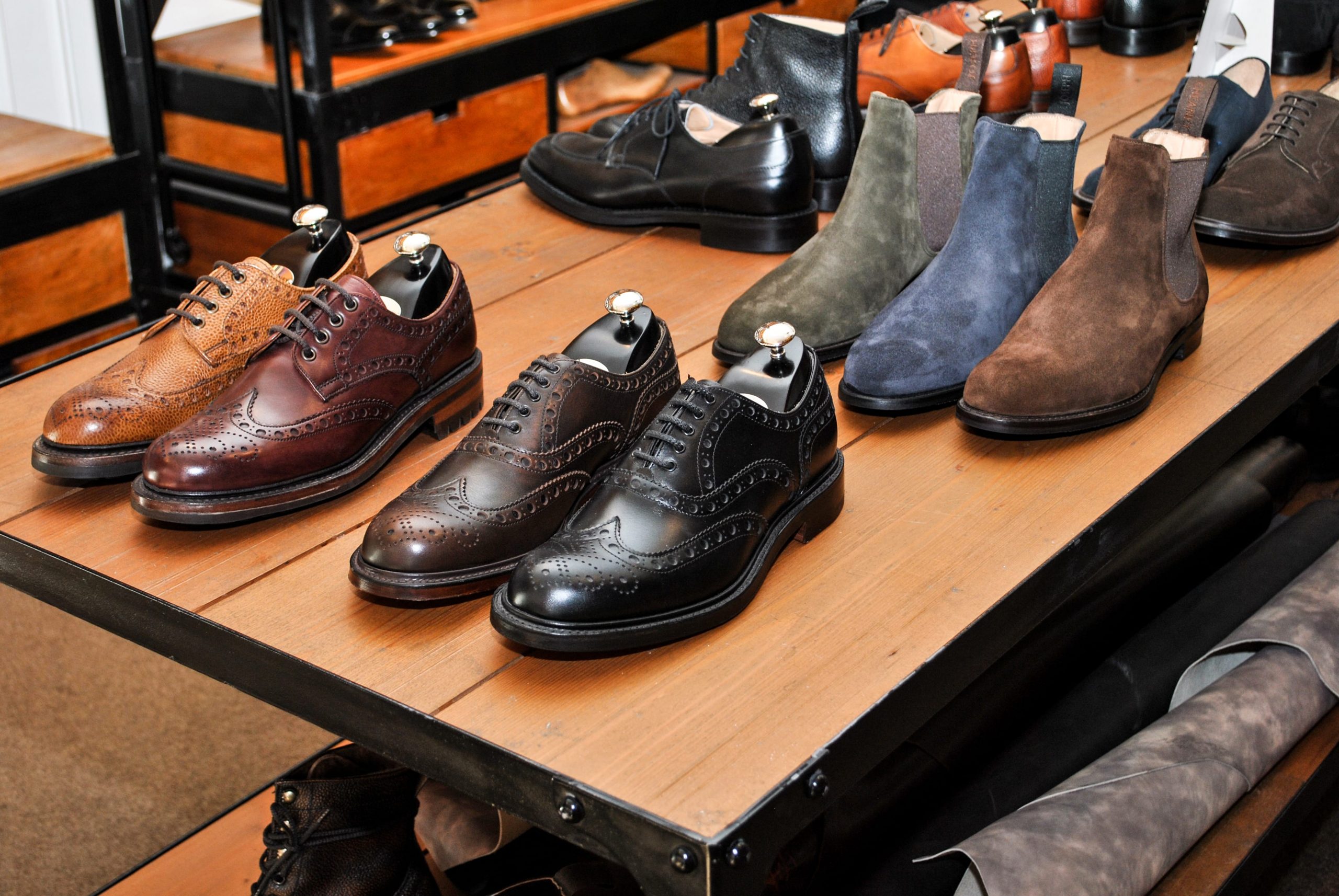 A row of completed Goodyear-welted shoes in a Cheaney showroom.