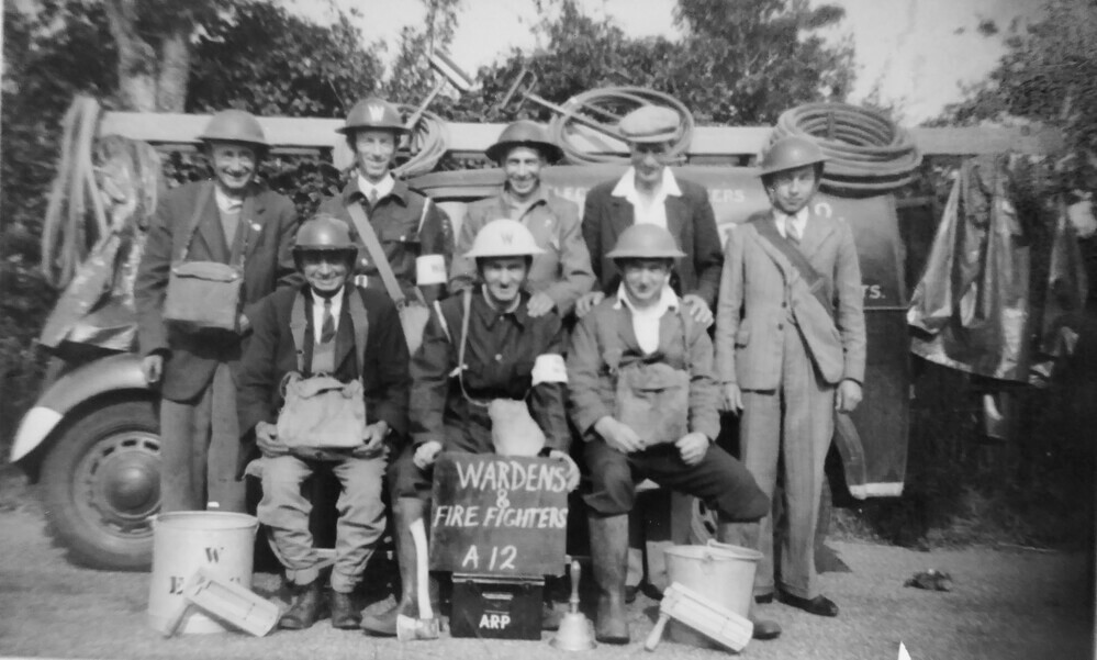This image features Mr Barr’s grandfather (back row, second from the left) wearing the early "overall" style of the ARP Civil Defence uniform in Clacton. Notably, the backdrop includes his Ford work van bearing the word "television." His grandfather was a pioneer in his local community, owning a radio and electrical shop and installing an early television in the family home in the late 1930s before broadcasts ceased for the war.